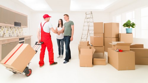Local removal team handling furniture in a Finsbury street