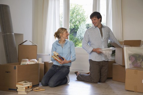 Professional movers navigating stairs in a Finsbury flat
